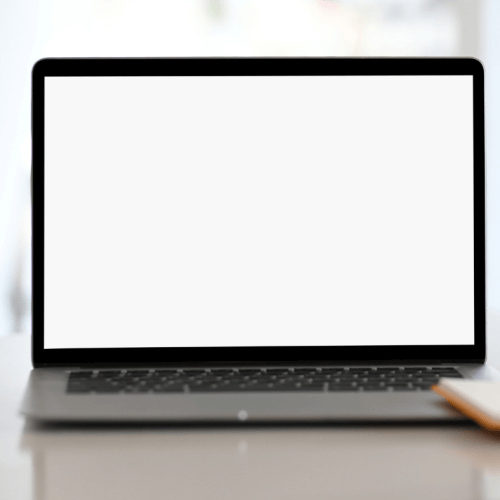 A laptop with a blank screen placed on a flat surface, featuring a keyboard and trackpad.